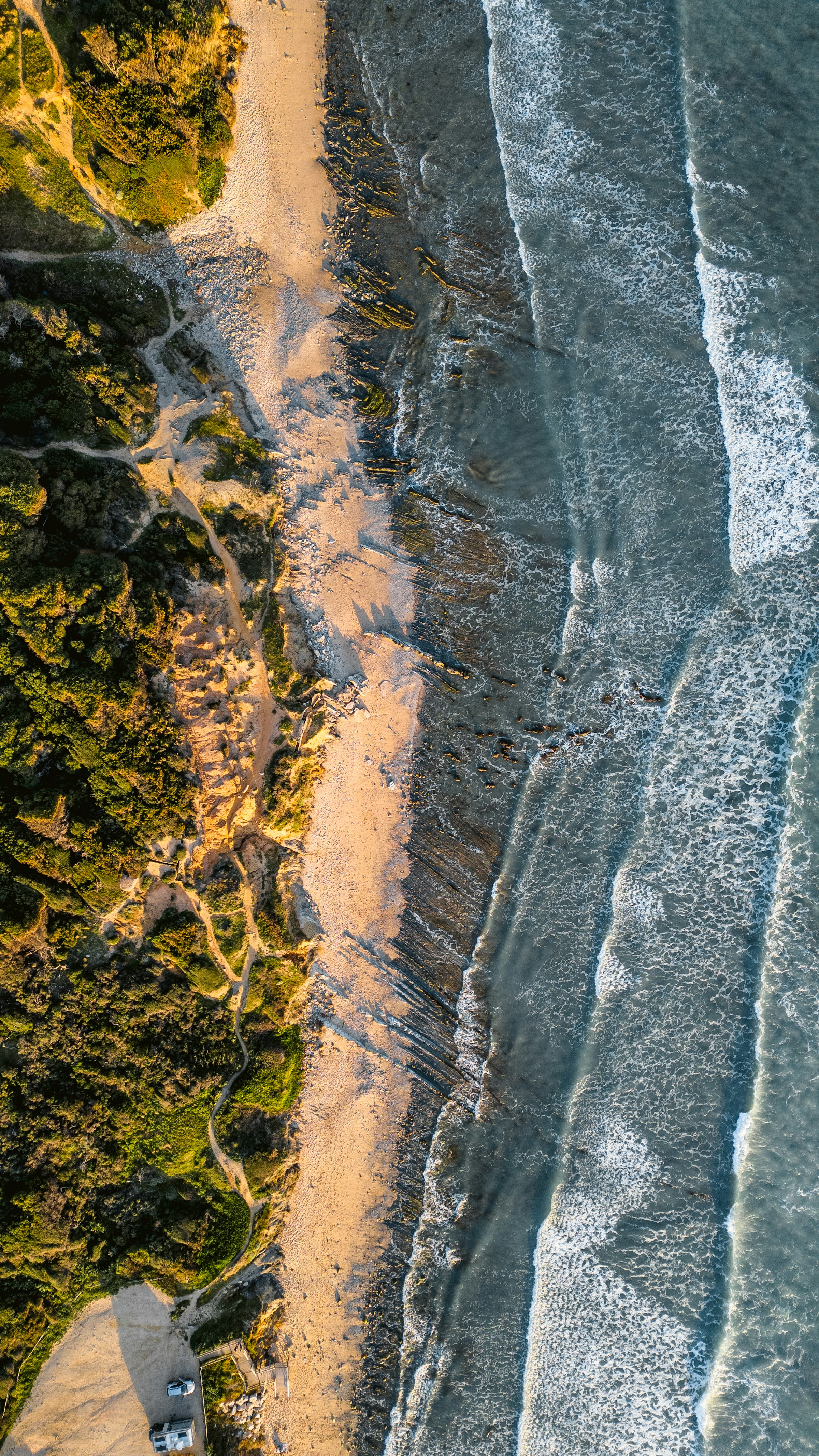 Ocean waves meeting a quiet sandy coast